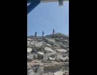 Guy in short shorts does handstands 