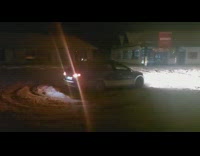 Car Circles Around Snow-Covered Parking Lot