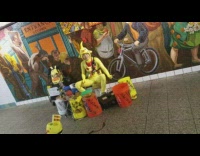 man yellow chicken outfit playing drums