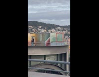 Guy and a girl dances on the roof deck 