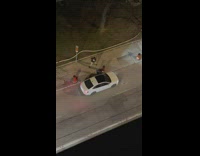 Man tiktok dance beside the parked car door