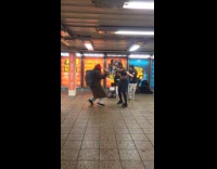 Woman dances to group performing subway station