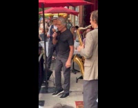 Tony Danza sing on street outside restaurant