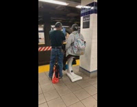 Woman rides on blue white exercise bike at subway station