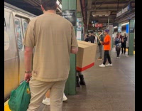 Person dressed as box costume rides subway