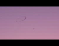 Black ring of smoke on sky sunset