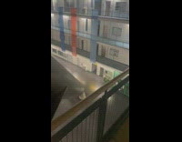Person ride long slide inside university building