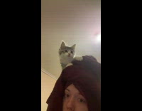 Girl red towel and kitten on head