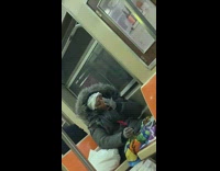 Lady on subway rubs blue ointment nose 