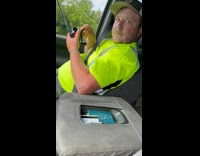 Guy tries fishing inside of car off bridge in traffic