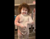Little baby in diaper covered in white powder 
