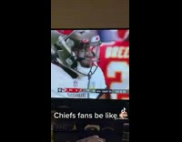 Guy watches super bowl game living room