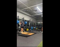 Guy finishes lifting weights and does backflip
