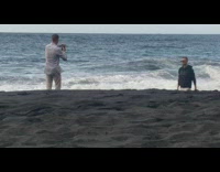 Guy black hoodie shades walk beach overcast