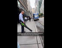 Man leaf blowing nothing on sidewalk