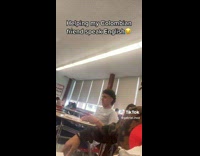 Man Messes with Friend as he Speaks with Teacher