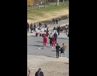 Three women in Christmas Sweaters jump shot at the park