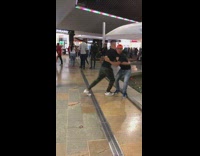 Two guys pretend to fight at the mall and push each other into fountain pool