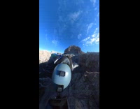 Person paragliding turns around in the air