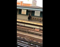 Guy with boots with mohawk waiting for train at train station