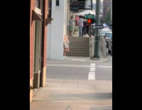 Blonde girl grey jacket street stairs tripod