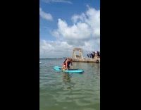 Woman fell from the surfboard at beach
