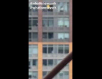 Yellow shirt guy cleans apartment window bridge 