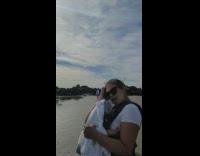 Woman in green dress lie down sideways at the beach shore Part 2