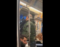 Man rides subway with pigeon on shoulder