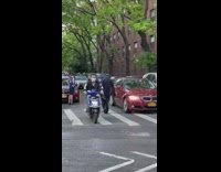 Guy in scream costume walks across street