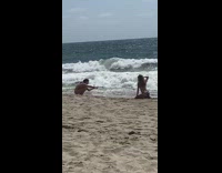 Girl bikini kneel pose hit beach waves