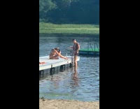 Girl white dock guy climbs ladder lake 