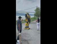 Bumblebee from Transformers takes photos near bridge 
