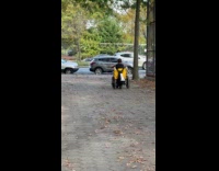 Man rides custom scooter attached to wheelchair 