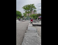 Guy on a Bicycle Balances Soccer Ball on Head 