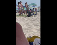 2 women and 1 guy dance at beach for video 