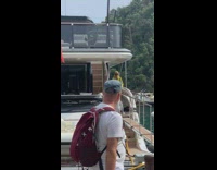 Woman in mustard dress poses for her daughter to take pictures