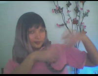 Pink shirt girl kisses snake on shoulder 