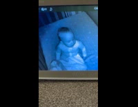 Baby tries to stay awake in crib