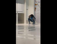 Curly guy grey jacket squat dance mall