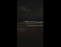 Woman in blue bikini poses near the search and rescue