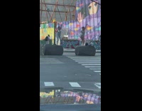 Two girls matching silver bodysuits move arms