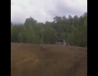 Grey car no doors jumps dirt hill