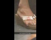 Lady pinky toe hangs off sandals shoe