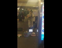Guy long white dress guitar train station