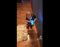 Boy shoots bubbles onto floor slips falls 