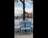 Black shirt guy practices boxing blue chair