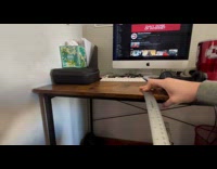 Man taps ruler shakes on table edge