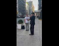 Guy listen to the music of the other guy in front of him 