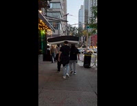 Group walk on street carry mattress on head